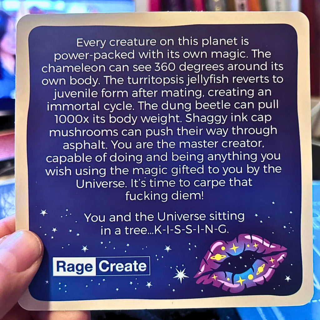 Card with text and a colorful lip graphic, held by a hand.