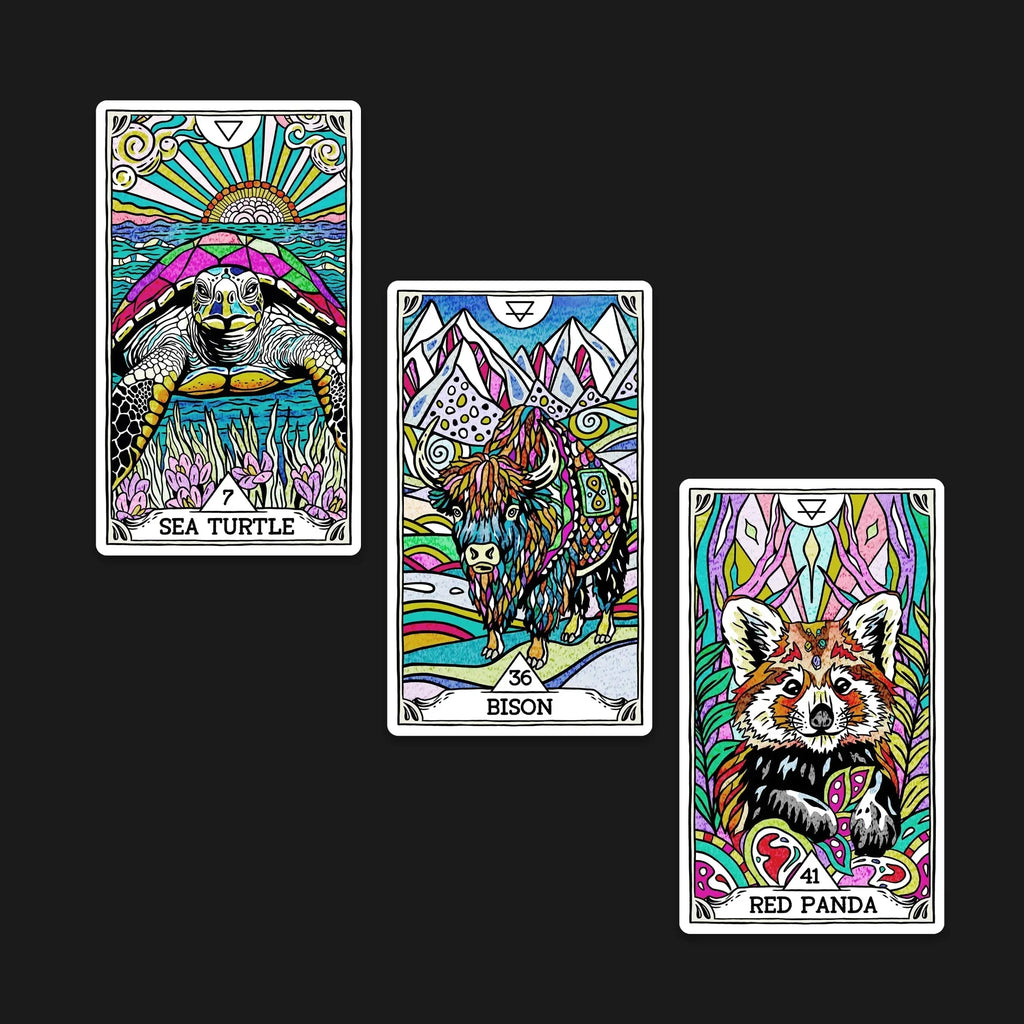 Three colorful tarot-style sticker cards featuring a sea turtle under radiating sunburst, a mystical bison surrounded by mountains, and a red panda with ornate psychedelic patterns on a black backgrou