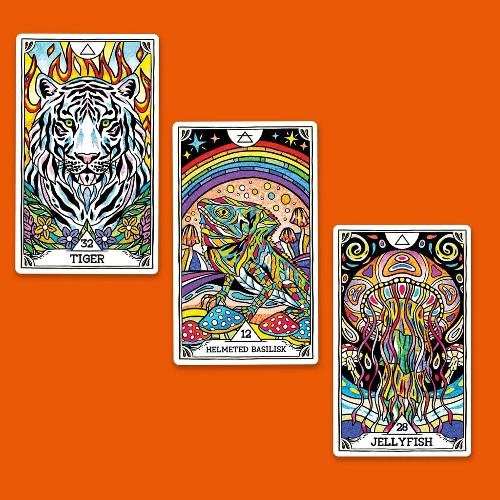 Three vibrant tarot-style oracle cards featuring a white tiger with flames, a rainbow-crowned basilisk, and a psychedelic jellyfish displayed against a bold orange background.