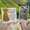 Two wooden easel card stands displaying an affirmation card with a whimsical tree door and an Anaconda oracle card with vibrant psychedelic patterns, set on weathered wood with white daisies and lush