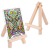 Wooden easel card stand displaying a vibrant tarot card numbered 24 with multicolored antelope illustration and ornate decorative borders, with a second empty stand visible in background.