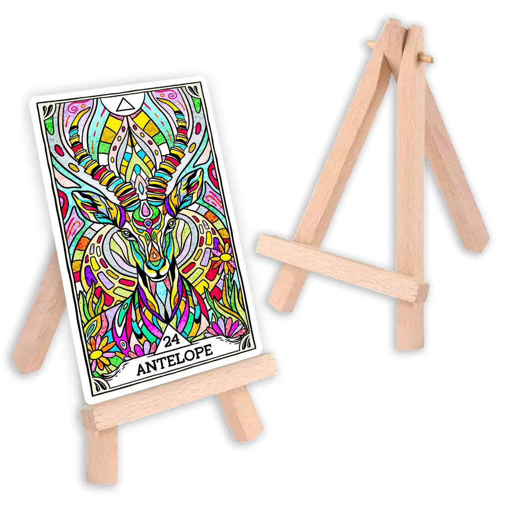 Wooden easel card stand displaying a vibrant tarot card numbered 24 with multicolored antelope illustration and ornate decorative borders, with a second empty stand visible in background.