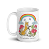 White ceramic mug featuring a whimsical illustration of a tan fox surrounded by red-and-white spotted mushrooms, butterflies, and clouds beneath a vibrant rainbow, with the text 'GO THE F*CK OUTSIDE'