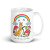 White ceramic mug featuring a whimsical forest scene with a smiling fox, red and white spotted mushrooms, butterflies, clouds, and a bright rainbow overhead with the text 'GO THE F*CK OUTSIDE' at the