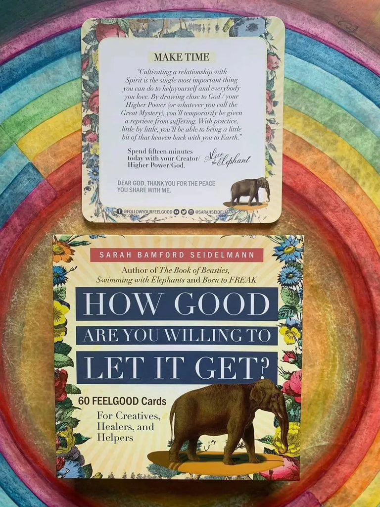 Sarah Bamford Sedelmann's 60 FeelGood card deck displayed on a vibrant rainbow-colored surface, showing the colorful floral-bordered box and a single inspirational card with an elephant illustration.