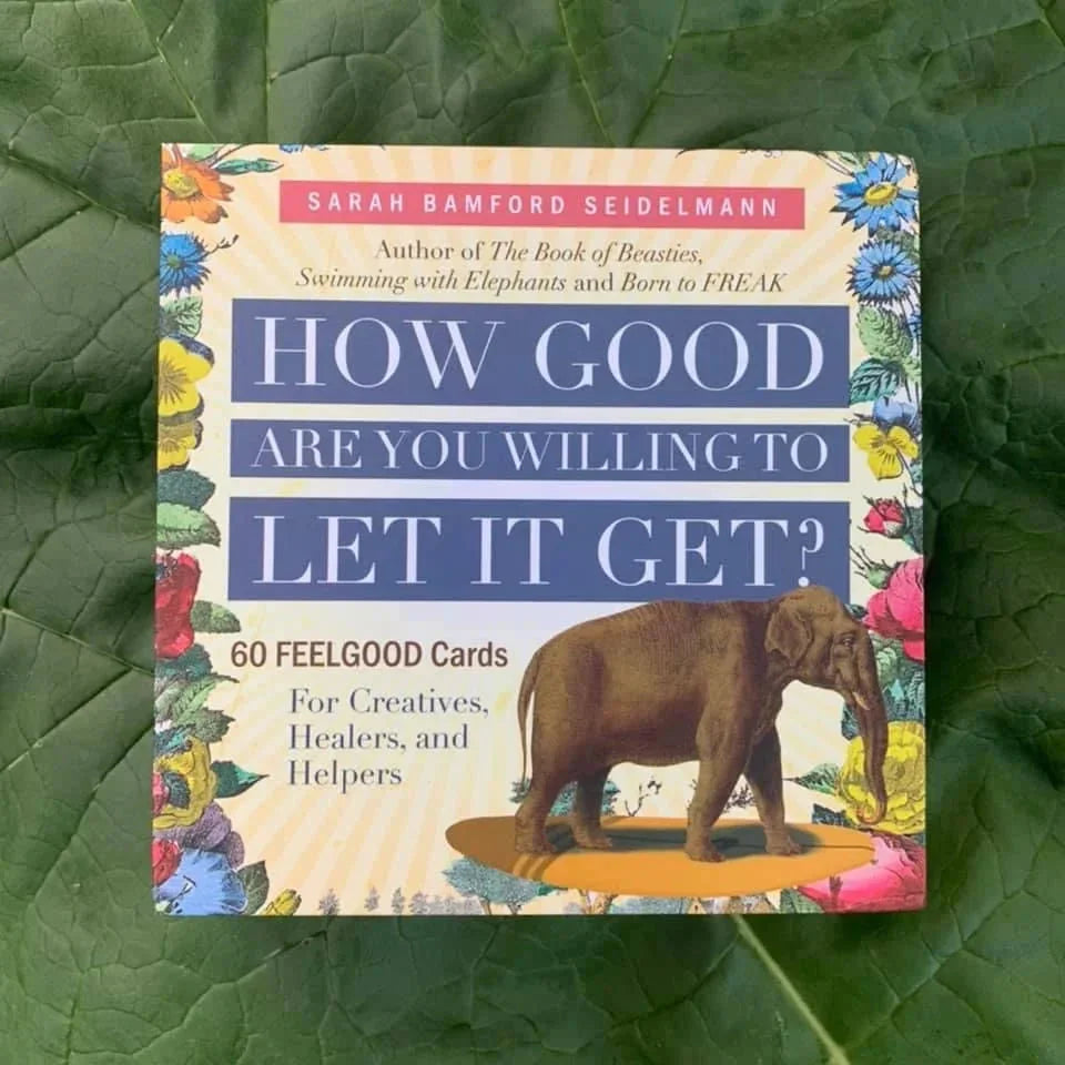 Card deck box featuring Sarah Bamford Seidelmann's "How Good Are You Willing to Let It Get?" with colorful floral borders and an illustrated brown elephant, displayed on a green leafy background.