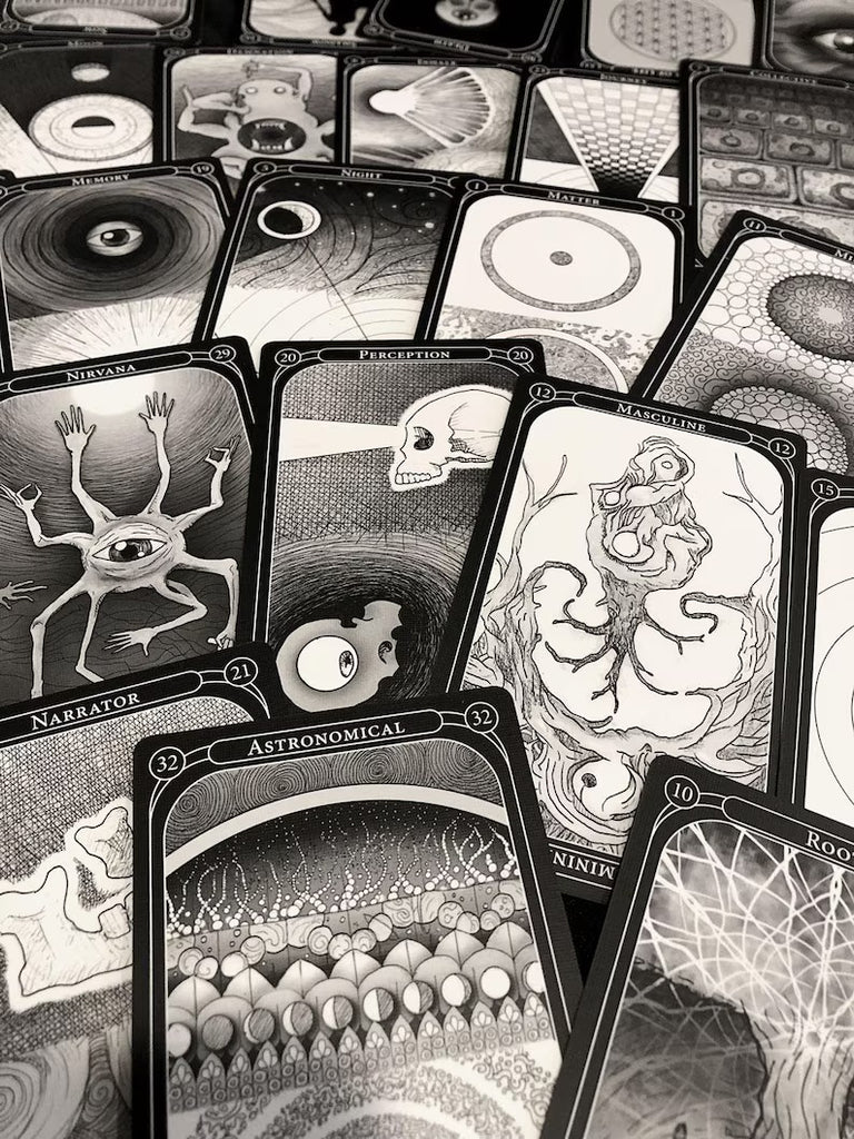 The Eigengrau Oracle Deck Limited Drop by Rage Create features intricately illustrated black and white dual-sided cards with surreal art—eyes, skulls, abstract patterns, creatures—and labeled titles like Narrator, Astronomical, and Perception.