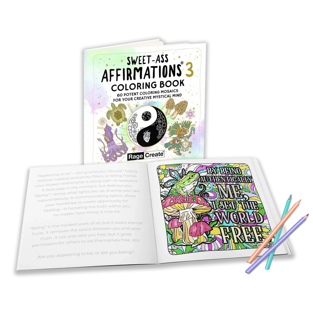 Open coloring book showing an affirmation page with mushrooms and botanical designs alongside motivational text, with three colored pencils displayed in the foreground.
