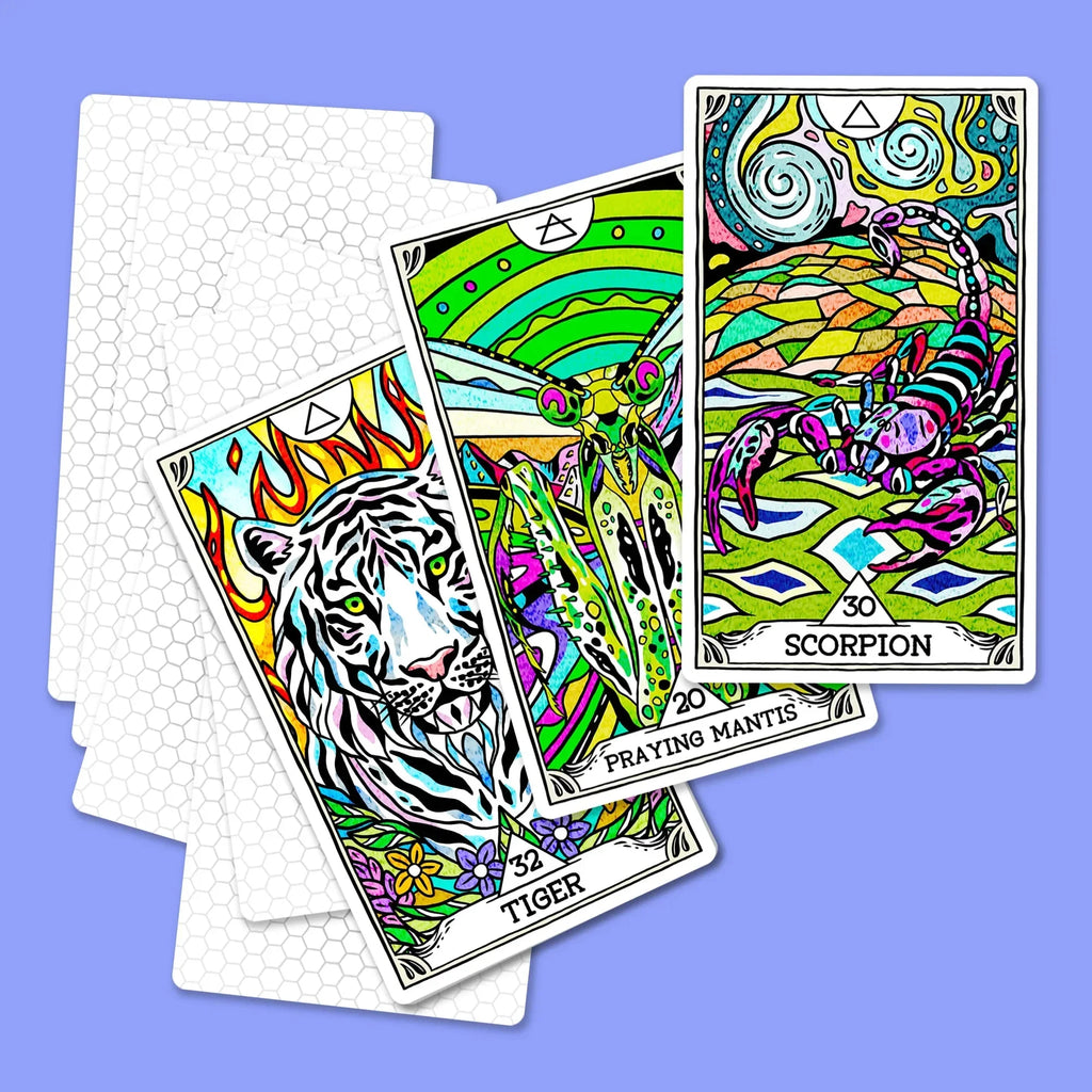 Three colorful tarot cards from The Beasties Oracle Deck featuring a striped tiger with flames, a praying mantis in a vibrant landscape, and a scorpion under swirling skies, fanned on a purple backgro